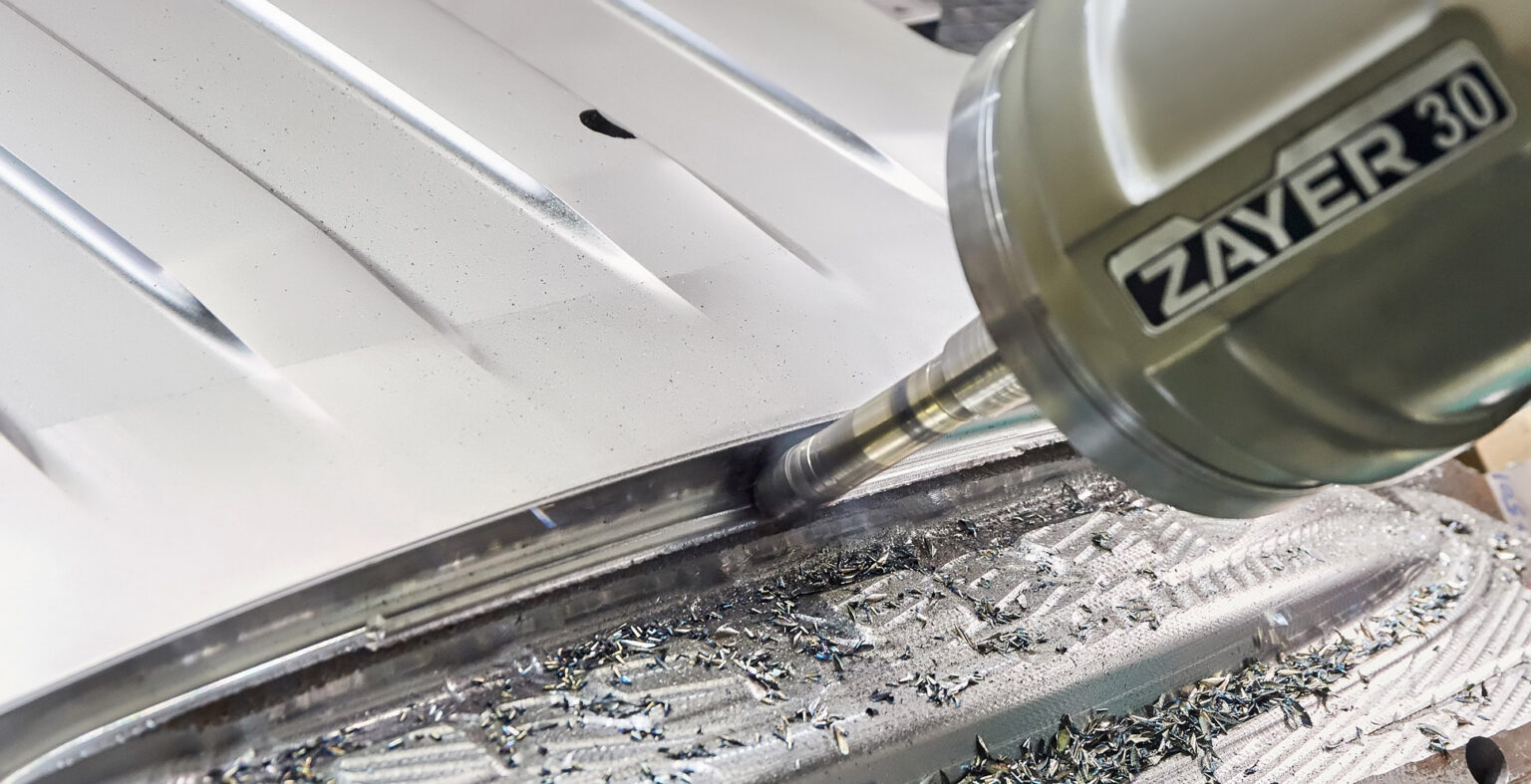 Zayer EMC CNC-Fräsmaschine bei der Bearbeitung von Metallteilen.